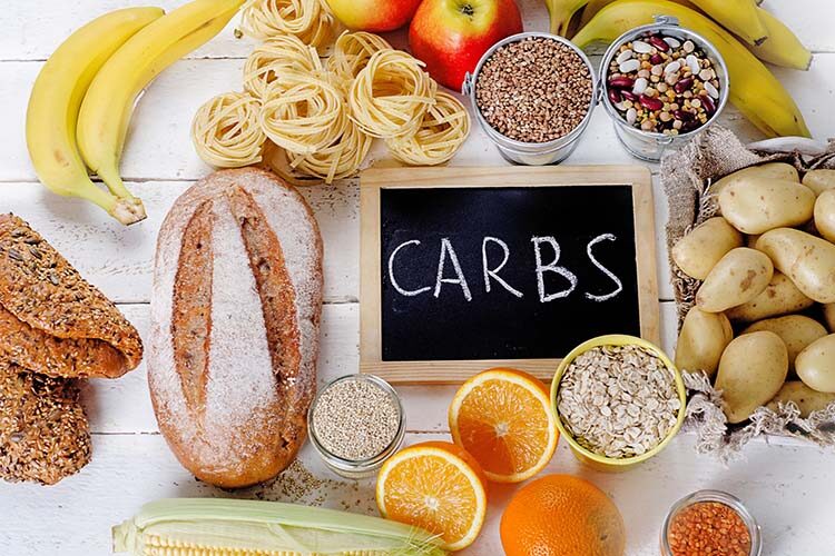 Top view of healthy carbs carbohydrates laid out on a table top.