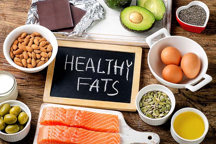 Top view of healthy fat foods displayed on a table.
